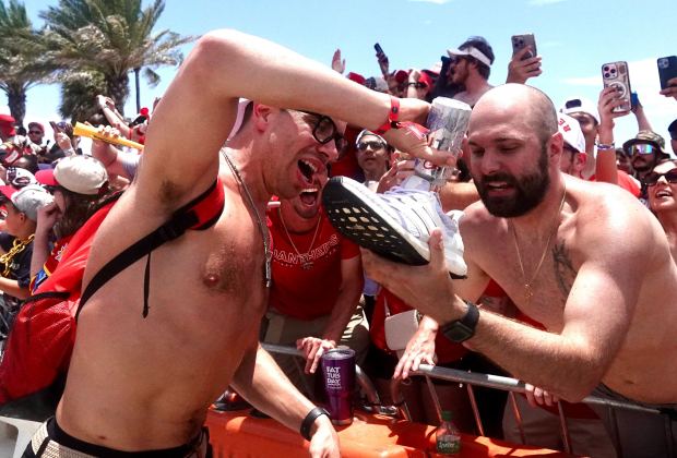 Florida Panthers’ Evan Rodrigues signs a shoe along the route...
