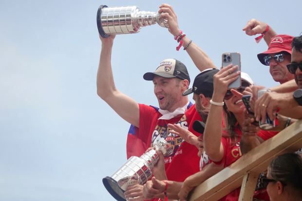 Florida Panthers’ Sergei Bobrovsky greets fans along the route of...