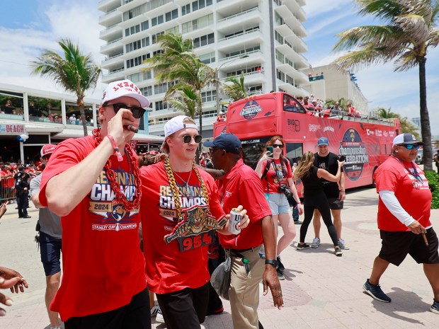 Niko Mikkola, left, and Anton Lundell of the Florida Panthers celebrate with fans during the 2025 Stanley Cup championship parade on Fort Lauderdale beach on Sunday, June 22, 2025. (Mike Stocker/South Florida Sun Sentinel)