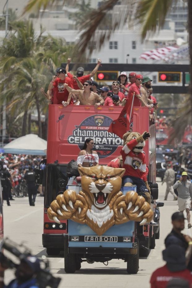 One of the buses carrying members of the Florida Panthers passes fans along State Road A1A on Fort Lauderdale beach during the 2025 Stanley Cup championship parade on Sunday, June 22, 2025. (Mike Stocker/South Florida Sun Sentinel)