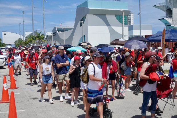 Fans wait in line to get a Water Taxi at...