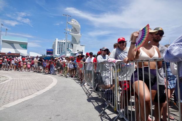 Fans wait in line to get a Water Taxi at...
