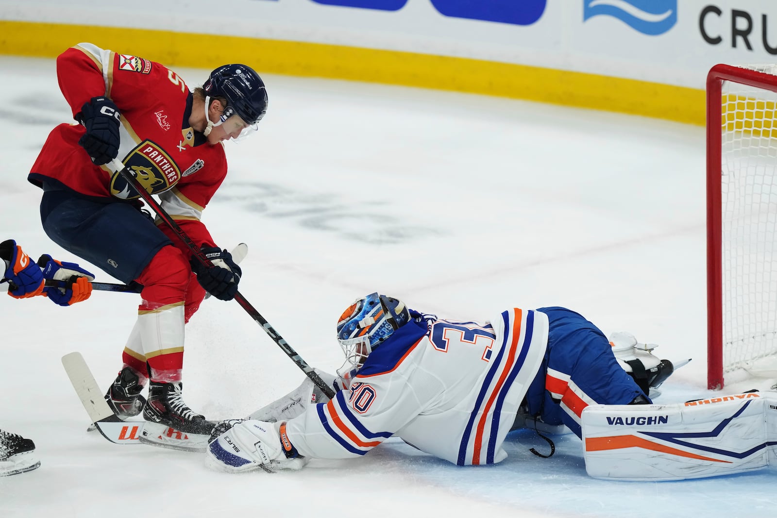 Edmonton Oilers goalie Calvin Pickard (30) makes a save against Florida Panthers' Anton Lundell, left, during the second period in Game 4 of the NHL hockey Stanley Cup Final in Sunrise, Fla., Thursday, June 12, 2025. (Nathan Denette/The Canadian Press via AP)