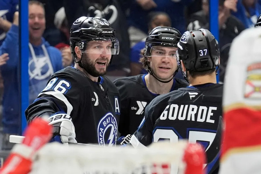 Tampa Bay Lightning right wing Nikita Kucherov (86) celebrates his goal against the Florida Panthers with center Brayden Point (21) and center Yanni Gourde (37) during the second period of an NHL hockey game Tuesday, April 15, 2025, in Tampa, Fla. (AP Photo/Chris O’Meara)
