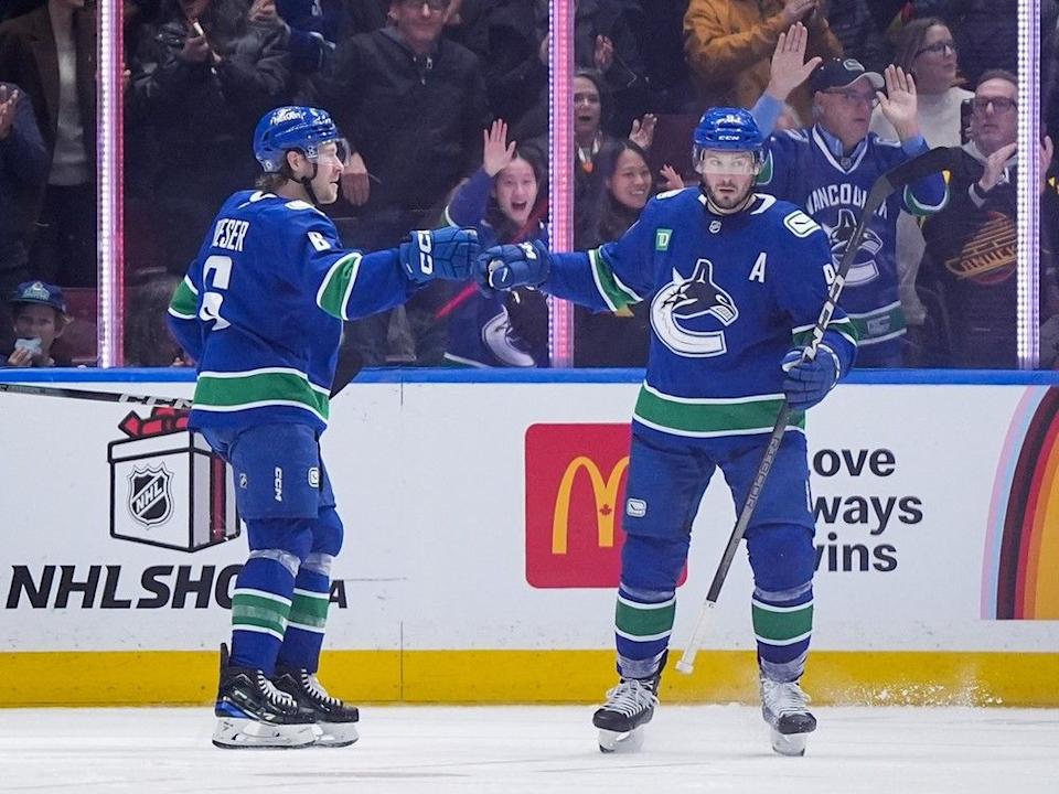 Canucks winger Brock Boeser celebrates his goal against the Florida Panthers with linemate J.T. Miller on Dec. 12, 2024 at Rogers Arena.