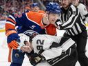 Los Angeles Kings' Brandt Clarke (92) and Edmonton Oilers' Vasily Podkolzin (92) rough it up during second period NHL action in Edmonton, Monday, April 14, 2025. 
