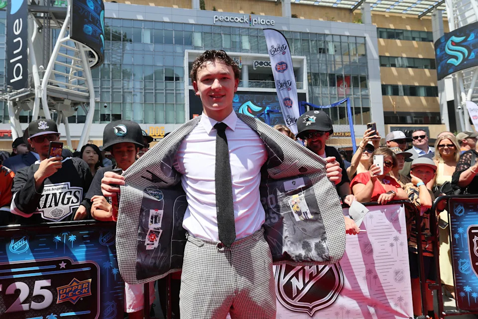 Matthew Schaefer shows off pictures of his mother, Jennifer, inside his suit jacket ahead of the 2025 NHL draft in Los Angeles. Jennifer Schaefer passed away following a battle with breast cancer. (Photo by Bruce Bennett/Getty Images)