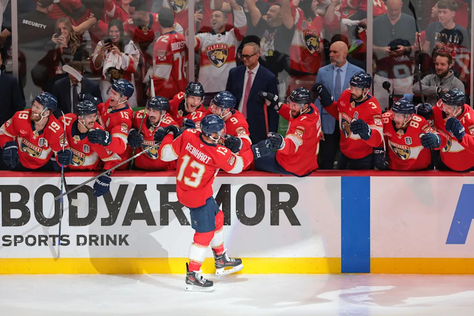 Florida Panthers center Sam Reinhart (13) celebrates after his fourth goal of Game 6 of the 2025 Stanley Cup Final against the Edmonton Oilers during the third period at Amerant Bank Arena, as ex-Peoria Rivermen trainer Brian Riedel looks on from right end of bench.