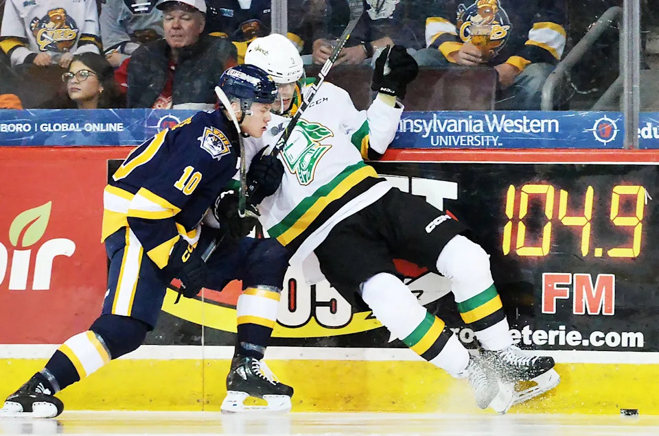 Erie Otters center Carey Terrance (left) checks London Knights' defenseman Sam Dickinson during a March 13, 2024, Ontario Hockey League game at Erie Insurance Arena. Terrance was traded by the NHL's Anaheim Ducks, whom he signed a three-year, entry-level contract with in April, to the New York Rangers on June 12. The Rangers received veteran forward Chris Kreider.