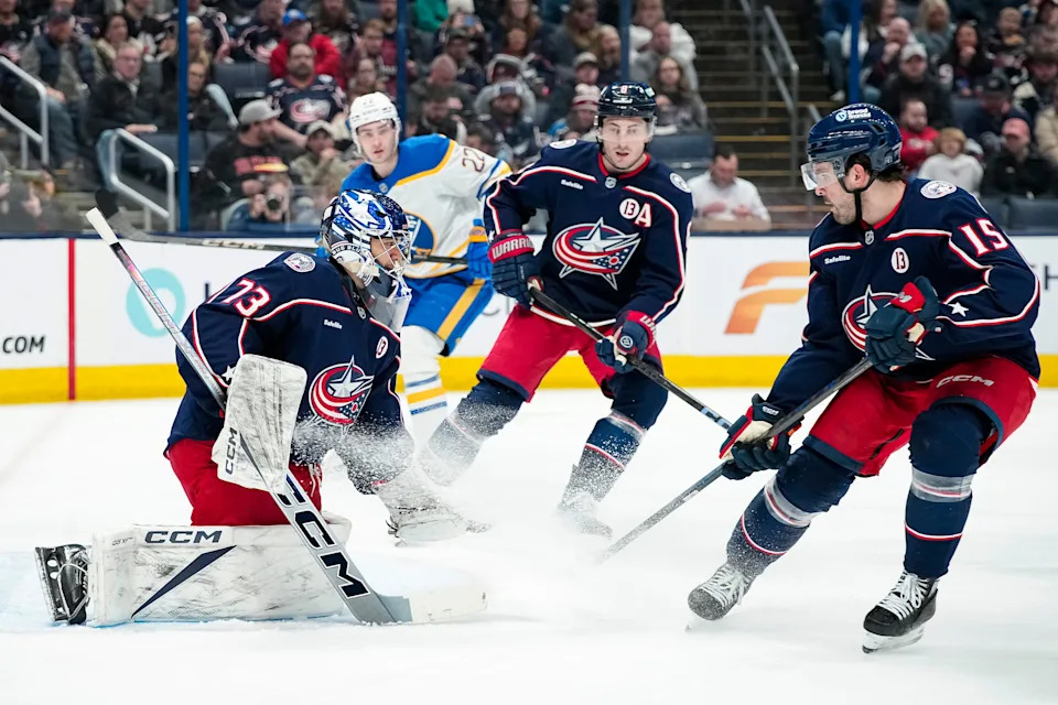 Columbus Blue Jackets goaltender Jet Greaves (73) stops a shot in front of defenseman Dante Fabbro (15) and defenseman Zach Werenski (8) during the second period of the NHL hockey game against the Buffalo Sabres at Nationwide Arena in Columbus on April 10, 2025.
