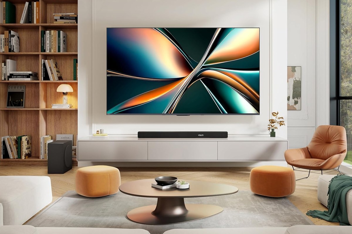 The Hisense U6 4K QLED TV hangs on the wall over a soundbar in a living room.