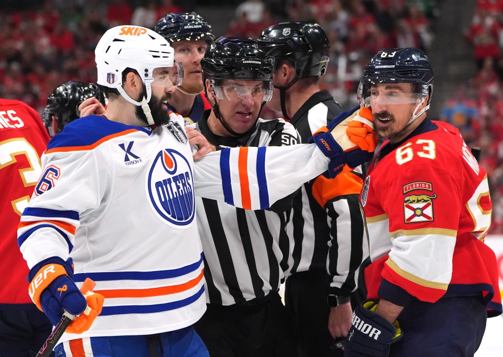 Edmonton's Jake Walman and Florida's Brad Marchand after the whistle during Game 3.