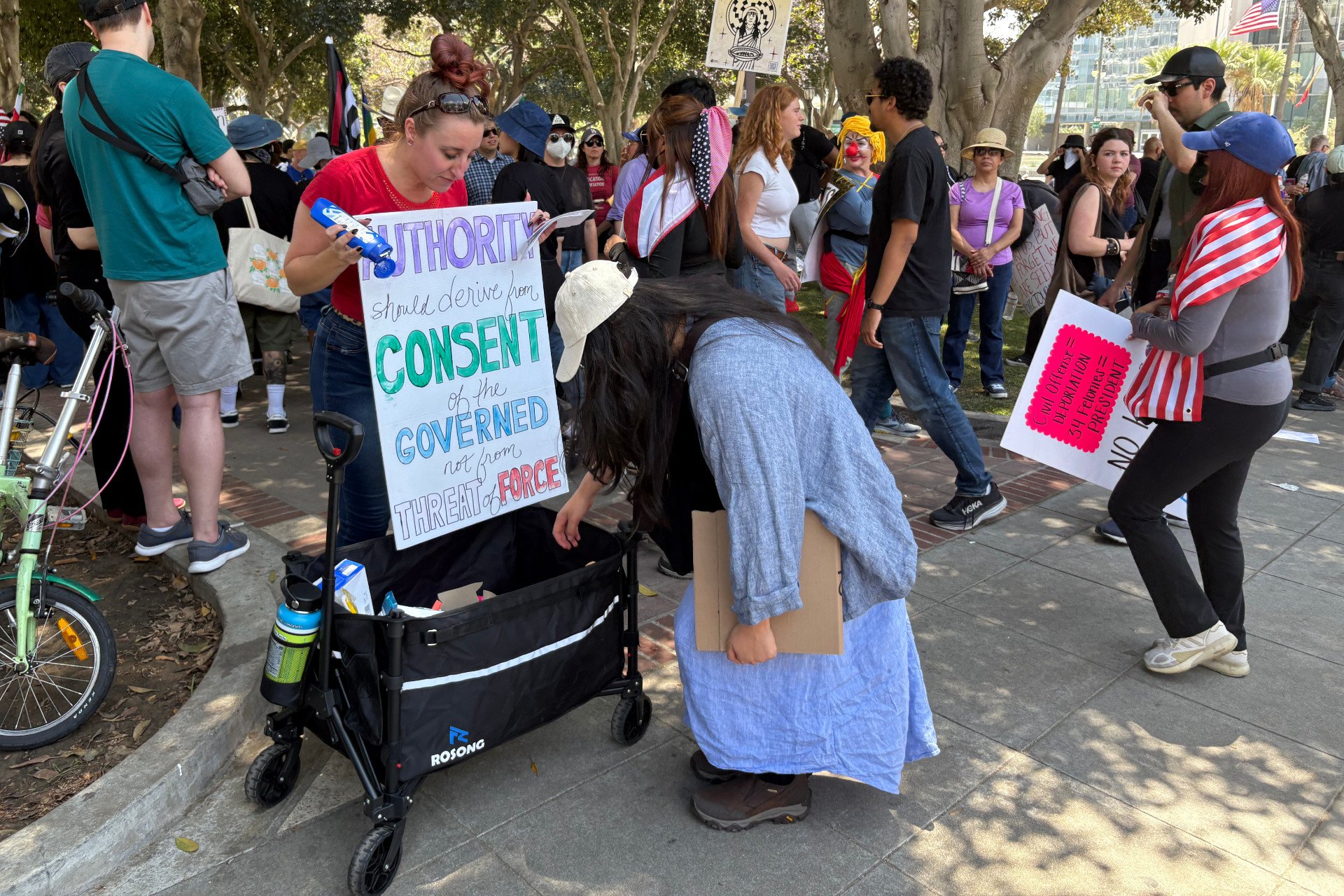 Hilaree Caldwell hands out snacks, water, sunscreen, and first aid items at the No Kings protest in downtown Los Angeles, California, on June 14, 2025.