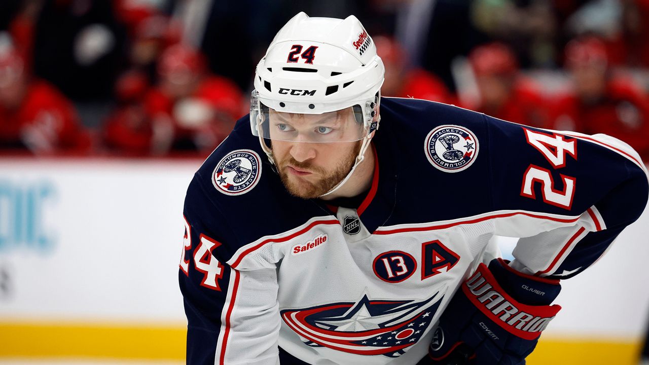 Columbus Blue Jackets' Mathieu Olivier (24) waits for a face-off against the Carolina Hurricanes during the first period of an NHL hockey game in Raleigh, N.C., Thursday, Jan. 23, 2025.