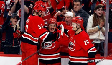 Carolina Hurricanes' Seth Jarvis, center, celebrates his goal with teammates Jackson Blake (53) and Sebastian Aho (20) during the second period of an NHL hockey game against the Utah Hockey Club in Raleigh, N.C., Saturday, Feb. 8, 2025. (AP Photo/Karl DeBlaker)