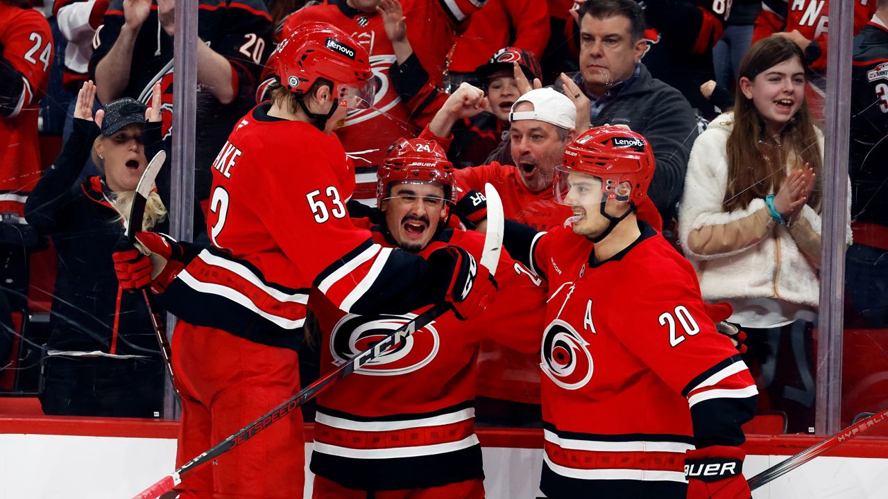 Carolina Hurricanes' Seth Jarvis, center, celebrates his goal with teammates Jackson Blake (53) and Sebastian Aho (20) during the second period of an NHL hockey game against the Utah Hockey Club in Raleigh, N.C., Saturday, Feb. 8, 2025. (AP Photo/Karl DeBlaker)