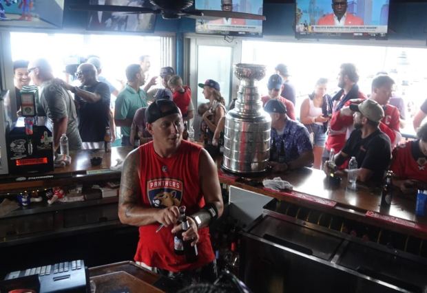 Bartender Adam Ginsberg celebrates the Florida Panthers winning the the...