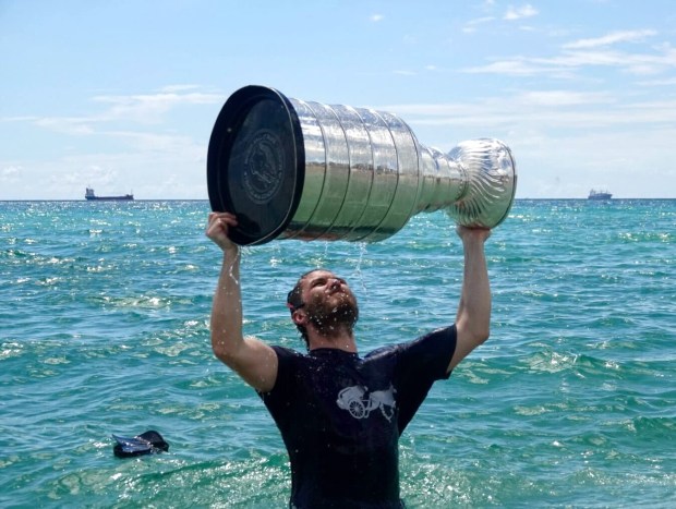 Florida Panthers Matthew Tkachuk celebrates winning the the Stanley Cup in the Atlantic Ocean near Elbo Room in Fort Lauderdale on Tuesday, June 25, 2024. (Joe Cavaretta/South Florida Sun Sentinel)