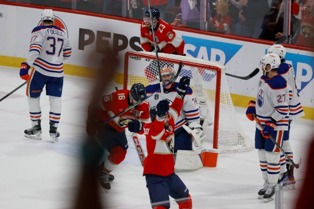 The team celebrates as Florida Panthers center Sam Reinhart (13)...