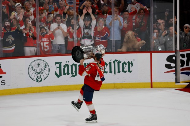 Florida Panthers center Aleksander Barkov (16) hoists the Stanley Cup...
