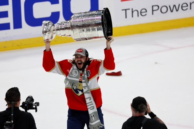 Florida Panthers defenseman Josh Mahura (28) hoists the Stanley Cup...
