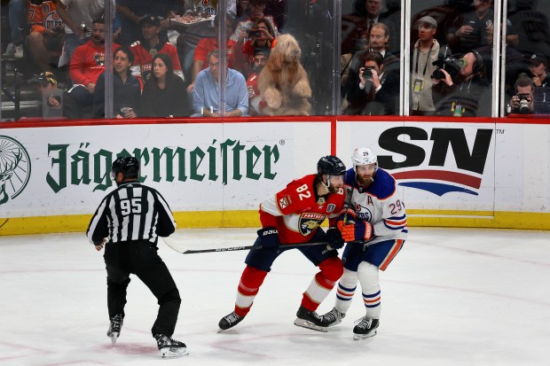 Cliff Brush, 34, with his dog, Brodie, rinkside as the Florida Panthers take on the Edmonton Oilers in Game 7 of Stanley Cup Final at Amerant Bank Arena in Sunrise on Monday, June 24, 2024. (Mike Stocker/South Florida Sun Sentinel)
