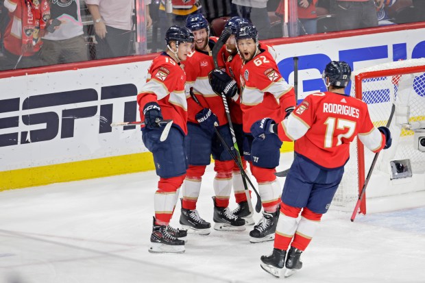 Florida Panthers center Carter Verhaeghe celebrates with teammates after scoring...