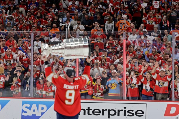 Fans watch Florida Panthers center Sam Bennett celebrate after winning...