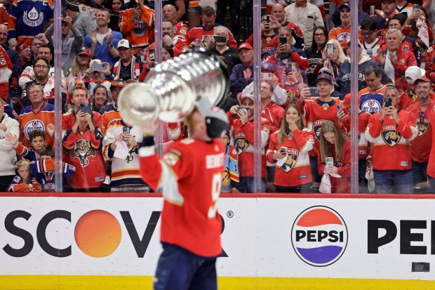 Fans watch Florida Panthers center Sam Bennett celebrate after winning...