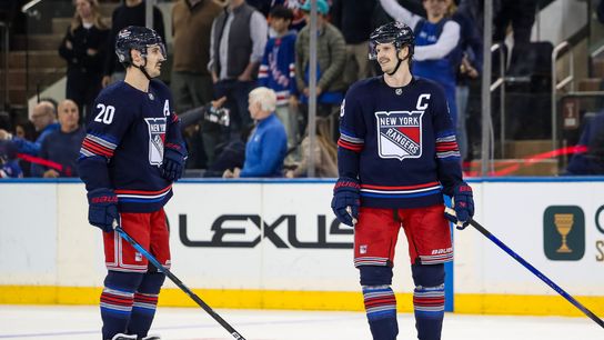 Nov 3, 2024; New York, New York, USA; New York Rangers defenseman Jacob Trouba (8) and left wing Chris Kreider (20) celebrate a win against the New York Islanders at Madison Square Garden.