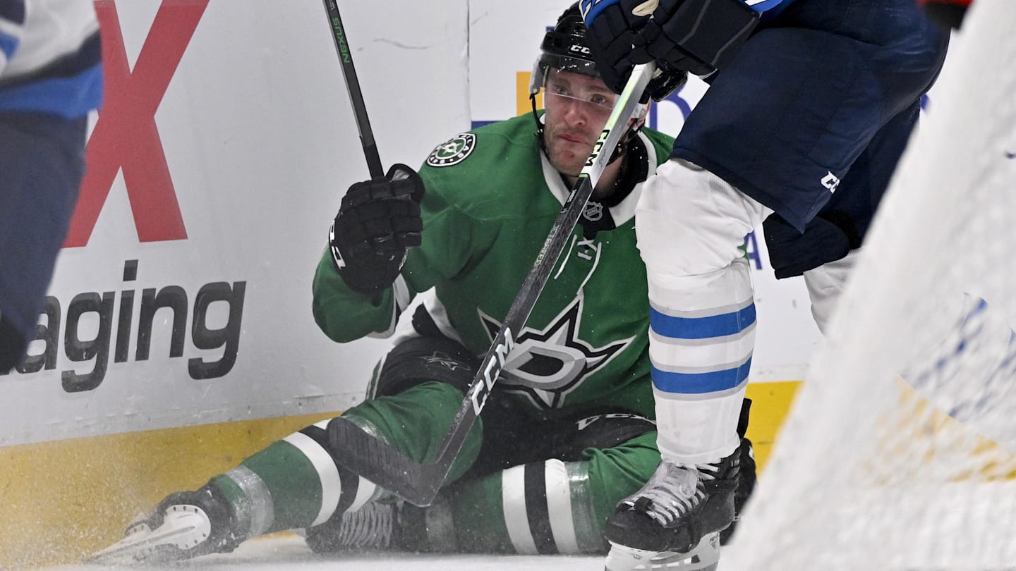 Apr 10, 2025; Dallas, Texas, USA; Dallas Stars right wing Mikko Rantanen (96) is taken down by Winnipeg Jets defenseman Dylan Samberg (54) during the second period at the American Airlines Center. Mandatory Credit: Jerome Miron-Imagn Images