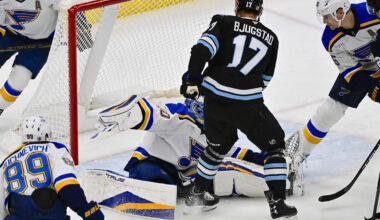 Jan 18, 2025; Salt Lake City, Utah, USA; St. Louis Blues goalie Jordan Binnington (50) blocks a shot by Utah Hockey Club center Nick Bjugstad (17) during second period at the Delta Center. Mandatory Credit: Christopher Creveling-Imagn Images