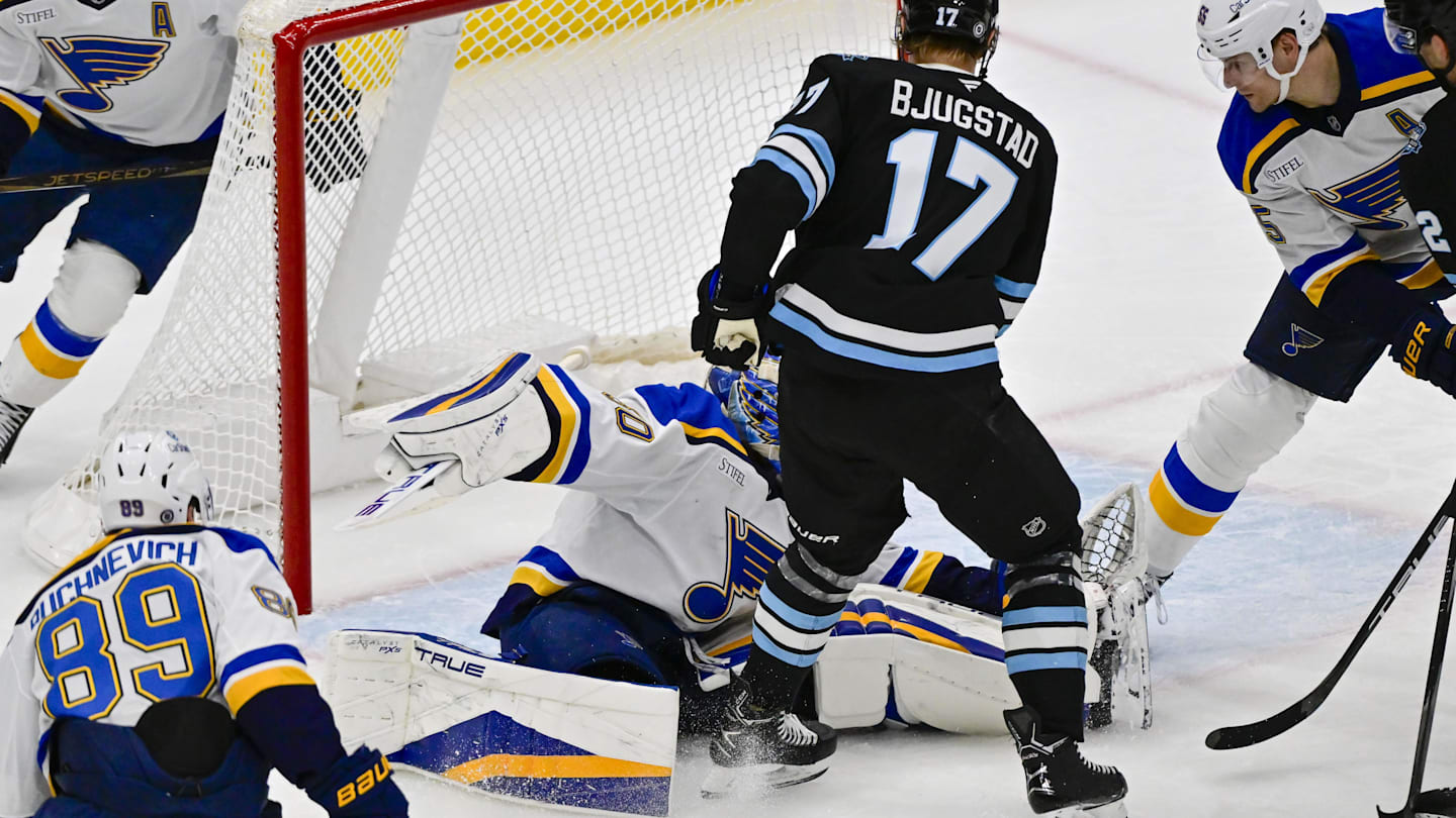 Jan 18, 2025; Salt Lake City, Utah, USA; St. Louis Blues goalie Jordan Binnington (50) blocks a shot by Utah Hockey Club center Nick Bjugstad (17) during second period at the Delta Center. Mandatory Credit: Christopher Creveling-Imagn Images