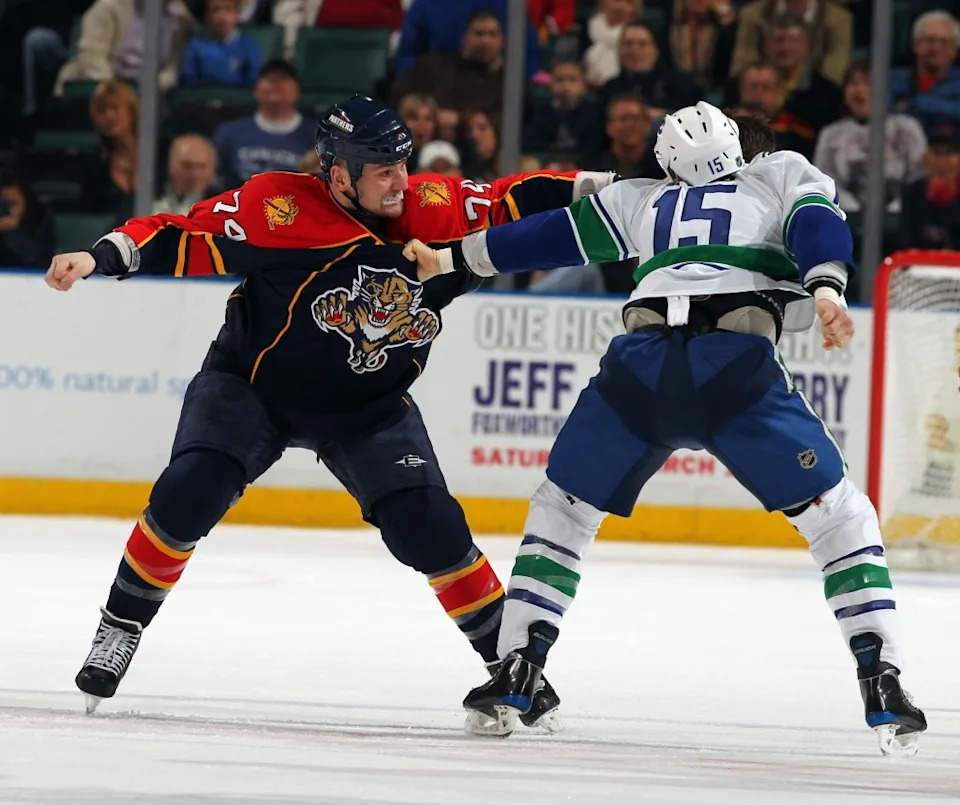 Nick Tarnasky of the Florida Panthers fights with Tanner Glass of the Vancouver Canucks on February 11, 2010. NHLI via Getty Images