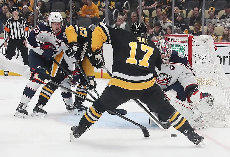 Jan 7, 2025; Pittsburgh, Pennsylvania, USA; Columbus Blue Jackets goaltender Elvis Merzlikins (90) defends the net against Pittsburgh Penguins right wing Bryan Rust (17) during the first period at PPG Paints Arena. Mandatory Credit: Charles LeClaire-Imagn Images