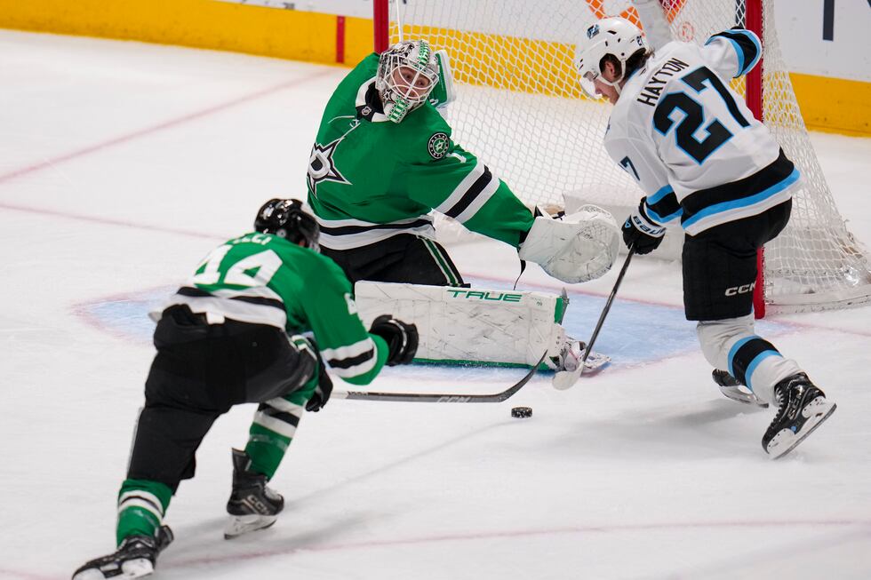 Utah Hockey Club center Barrett Hayton (27) attacks against Dallas Stars goaltender Casey...