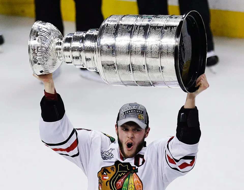 Chicago Blackhawks' Jonathan Toews hoists the Stanley Cup after defeating the Boston Bruins 3-2 in Game 6 to win the NHL hockey Stanley Cup Finals, Monday, June 24, 2013, in Boston. THE CANADIAN PRESS/AP/Charles Krupa