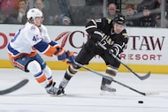 Dallas' Toby Petersen (right) makes a pass to a teammate against New York's Michael Grabner...