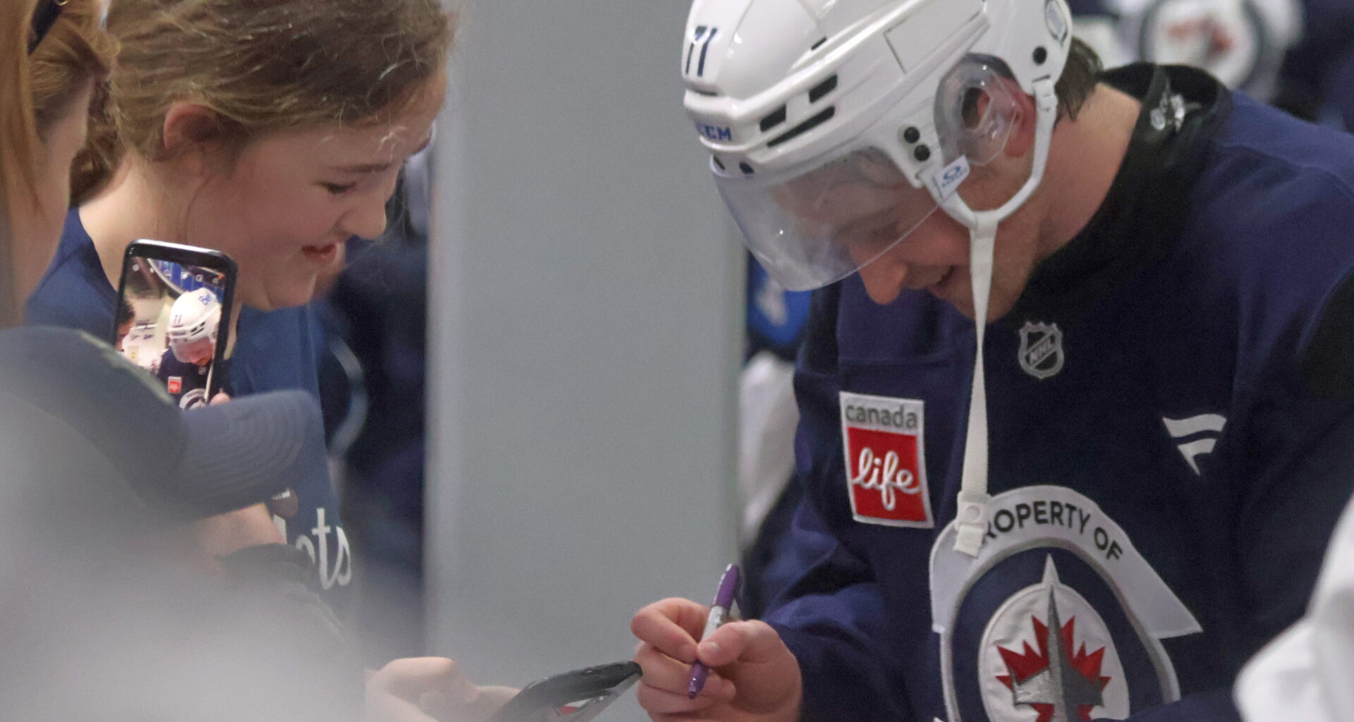 Winnipeg Jets third round draft pick Owen Martin signs autographs for kids after the end of the team