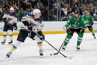 Dallas Stars left wing Jamie Benn (14) defends St. Louis Blues center Dylan Holloway (81)...