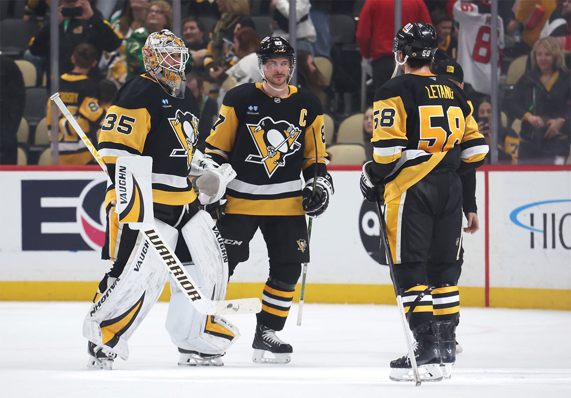 Pittsburgh Penguins goaltender Tristan Jarry (35) and center Sidney Crosby (87) and defenseman Kris Letang (58) celebrate after defeating the New Jersey Devils at PPG Paints Arena.
