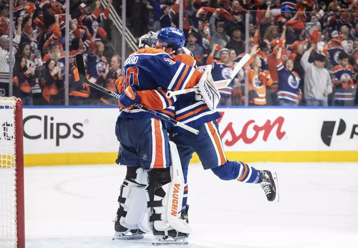 Edmonton Oilers goalie Calvin Pickard (30) and Connor Brown (28) celebrate the win over the Los Angeles Kings during NHL playoff action in Edmonton on Thursday, May 1, 2025. (Jason Franson/The Canadian Press via AP)