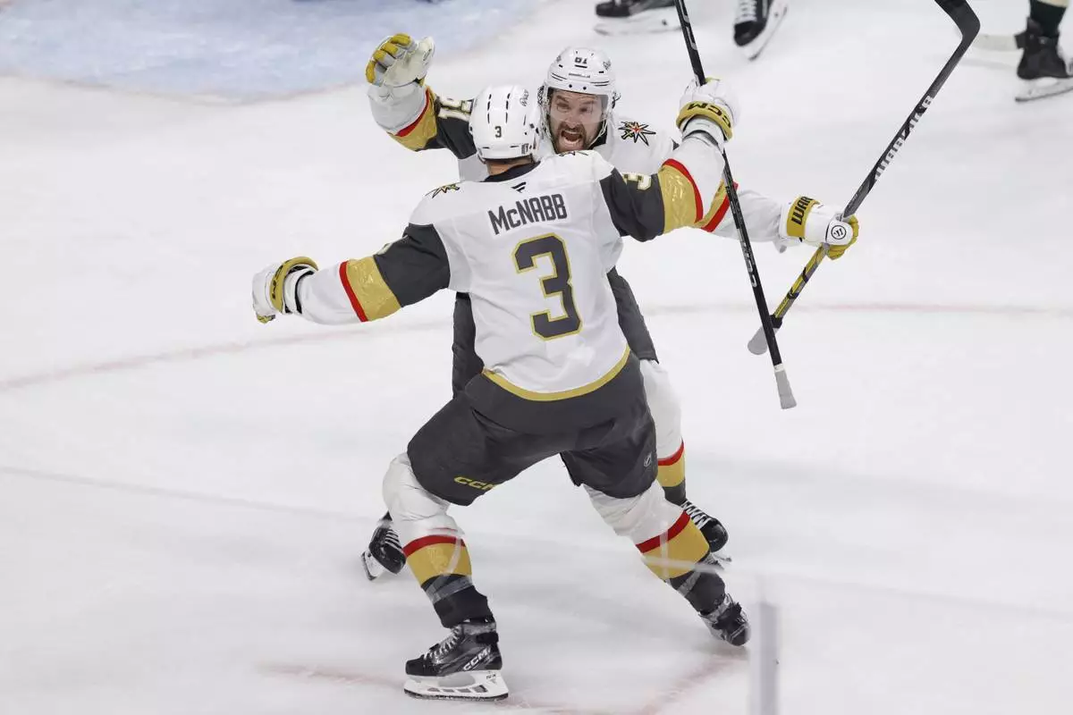 Vegas Golden Knights right wing Mark Stone (61) celebrates with defenseman Brayden McNabb (3) after scoring during the third period of Game 6 of a first-round NHL hockey playoff series against the Minnesota Wild, Thursday, May 1, 2025, in St. Paul, Minn. (AP Photo/Bailey Hillesheim)
