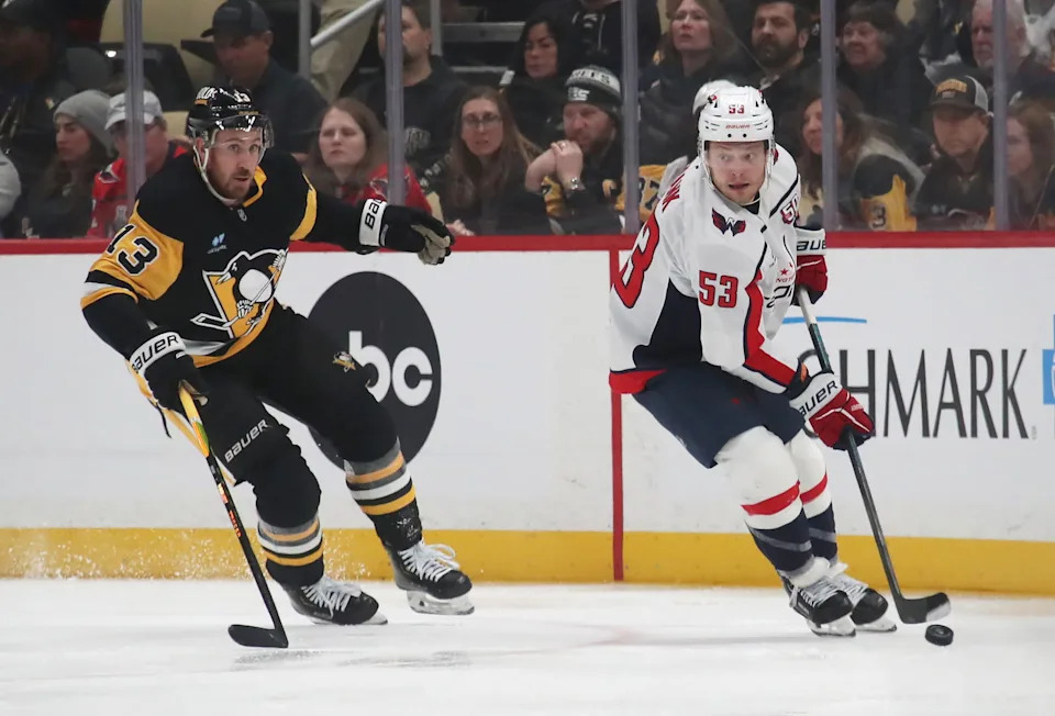 Feb 22, 2025; Pittsburgh, Pennsylvania, USA; Washington Capitals center Ethen Frank (53) moves the puck against Pittsburgh Penguins right wing Kevin Hayes (13) during the third period at PPG Paints Arena. Mandatory Credit: Charles LeClaire-Imagn Images