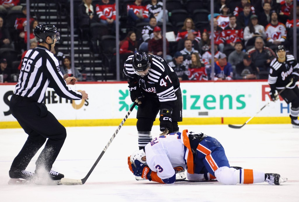 Adam Pelech #3 of the New York Islanders reacts to a high hit from Paul Cotter #47 of the New Jersey Devils during the second period at Prudential Center on April 13, 2025.