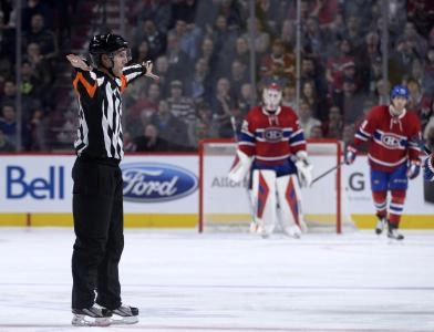 Nov 3, 2015; Montreal, Quebec, CAN; referee Chris Lee (28) confirms the no goal call after a coaches challenge from the Ottawa Senators during the third period against the Montreal Canadiens at the Bell Centre. Mandatory Credit: Eric Bolte-Imagn Images