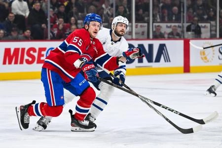 Montreal Canadiens forward engaged in battle with Toronto Maple Leafs defenseman Oliver Ekman-Larsson. Montreal Canadiens forward engaged in battle with Toronto Maple Leafs defenseman Oliver Ekman-Larsson.