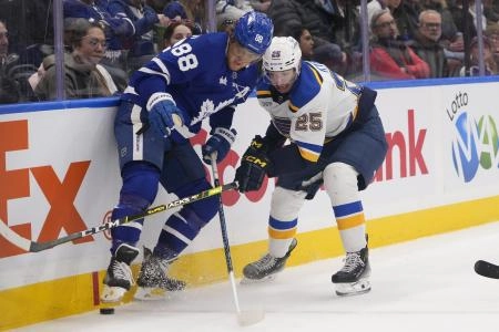St. Louis Blues forward Jordan Kyrou battling against Toronto Maple Leafs forward William Nylander. St. Louis Blues forward Jordan Kyrou battling against Toronto Maple Leafs forward William Nylander.