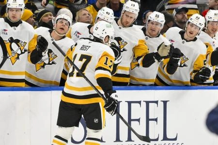 Apr 3, 2025; St. Louis, Missouri, USA; Pittsburgh Penguins right wing Bryan Rust (17) is congratulated by teammates after scoring against the St. Louis Blues during the first period at Enterprise Center