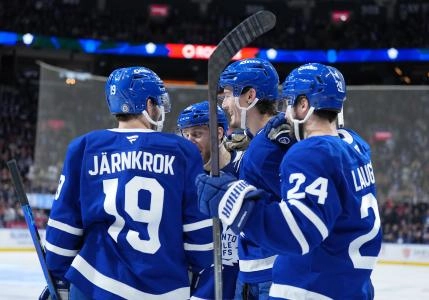 Toronto Maple Leafs forwards Scott Laughton and Calle Jarrnkrok celebrating a goal being scored with defenseman Phil Myers